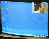 TV screen showing PC screen, face in small cutout, and number on the bottom